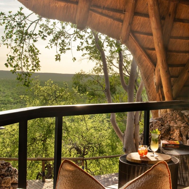 The sweeping view from the balcony at Ongava Lodge in Namibia is captured in this breathtaking travel photograph, overlooking the vast plains of Ongava Private Game Reserve. From this elevated vantage point, guests can watch wildlife roam freely across the savannah, framed by the warm hues of sunrise or sunset that illuminate the open landscape. The balcony offers a serene space to relax and immerse oneself in Namibia’s natural beauty, combining comfort with a front-row seat to the rhythms of the African wilderness. Ideal for safari enthusiasts, photographers, and nature lovers, this scene captures the sense of scale, tranquility, and awe-inspiring vistas that define Ongava Lodge. Inspiration Africa specializes in bespoke, tailor-made journeys to Namibia and across Africa, crafting unforgettable safari stays and immersive wildlife experiences in extraordinary landscapes.