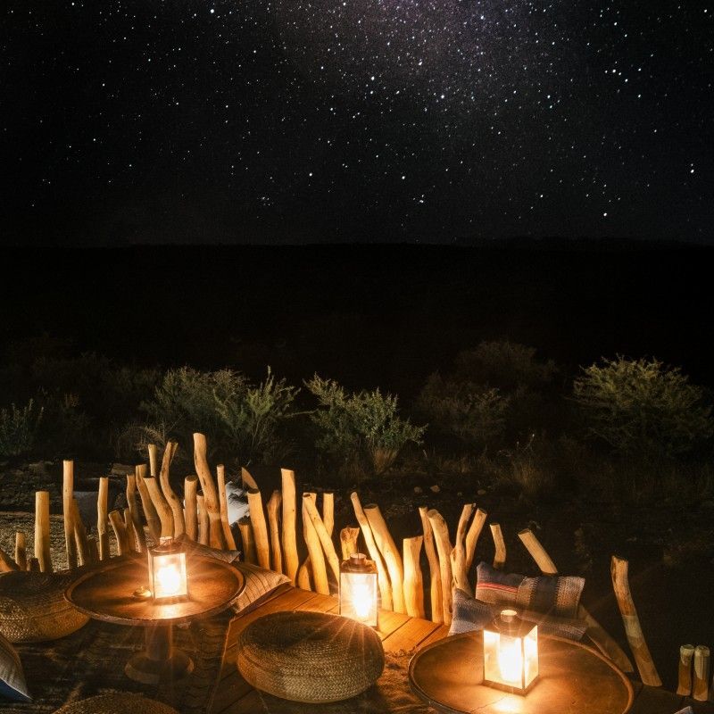 The Milky Way stretches across a breathtaking night sky above Zannier Omaanda in Namibia, captured in this stunning astrophotography travel photograph. Thousands of stars, shimmering in silvers, blues, and subtle purples, arc gracefully over the lodge and the surrounding desert plains, creating a sense of infinite scale and wonder. The remote location, far from light pollution, allows the galaxy’s intricate details and cosmic colors to shine in unparalleled clarity. Ideal for stargazers, photographers, and travelers seeking awe-inspiring natural beauty, this scene captures the serenity, majesty, and timeless magic of Namibia’s night skies. Inspiration Africa specializes in bespoke, tailor-made journeys to Namibia and across Africa, crafting immersive luxury experiences and unforgettable encounters with the continent’s most extraordinary landscapes—both day and night.