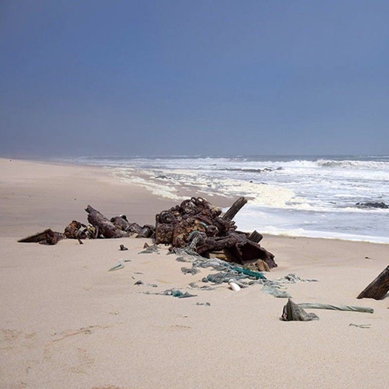 The hauntingly beautiful Skeleton Coast in Namibia is captured in this dramatic travel photograph, showcasing the stark contrast between the vast, arid desert and the churning Atlantic Ocean. Fog drifts over the shoreline, while scattered shipwrecks and bleached bones hint at the area’s storied history, giving the landscape an eerie yet mesmerizing character. Rolling sand dunes meet the crashing waves, creating a sense of isolation, scale, and raw natural power unique to this remote coastal wilderness. Ideal for adventure travelers, photographers, and nature enthusiasts, this scene captures the rugged beauty, solitude, and dramatic allure that define Namibia’s Skeleton Coast. Inspiration Africa specializes in bespoke, tailor-made journeys to Namibia and across Africa, crafting immersive wilderness experiences and unforgettable encounters with extraordinary landscapes.