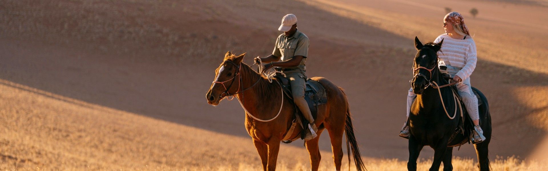 Gaze upon a sense of adventure as two travelers ride across sweeping sand dunes in the Namibian desert. This evocative photograph captures the vast scale of golden dunes, endless horizons, and the thrill of exploring one of the world’s oldest deserts. The scene reflects freedom, remoteness, and the raw beauty that defines Namibia’s landscapes. Experiencing the desert in this immersive way offers a unique connection to nature and a powerful sense of space. Inspiration Africa specializes in crafting bespoke, tailor-made journeys that deliver unforgettable desert adventures and extraordinary travel experiences across Africa’s most remarkable destinations.