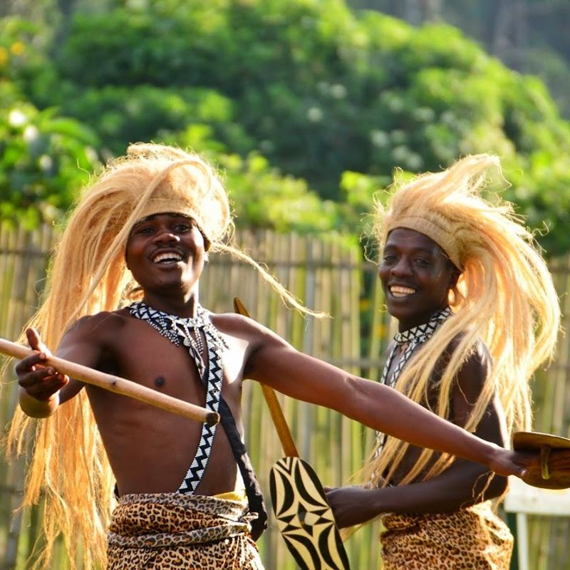 Two young warrior dancers in traditional dress perform with striking intensity in Rwanda, captured mid-movement against a backdrop of rolling hills. Their costumes, rhythms, and expressions reflect centuries of cultural heritage passed through generations. Moments like this reveal Rwanda’s deep artistic traditions, often experienced during local festivals or village visits. Inspiration Africa organizes tailor-made travel to Rwanda, offering opportunities to engage with communities, witness traditional dance, and explore the cultural richness beyond the country’s well-known wildlife. Travel with us to discover Rwanda through its people, stories, and vibrant living traditions woven into daily life. Inspiration Africa specializes in bespoke, tailor-made journeys to Congo and across Africa, crafting unforgettable safari experiences in extraordinary destinations.