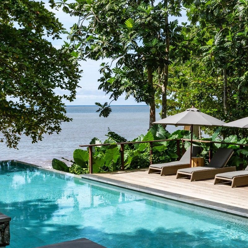 The infinity pool at Sundy Praia overlooks the sparkling waters of the Atlantic Ocean, creating a breathtaking tropical setting on the island of Príncipe in São Tomé and Príncipe. Surrounded by lush rainforest, swaying palm trees, and pristine coastline, this luxurious retreat blends seamlessly with the natural beauty of one of Africa’s most exclusive island destinations. The tranquil atmosphere, crystal-clear water, and spectacular ocean views evoke a true sense of paradise, offering travelers an unforgettable escape in an untouched tropical environment. Inspiration Africa specializes in bespoke, tailor-made journeys across São Tomé and Príncipe and the African continent, creating immersive travel experiences that combine extraordinary natural beauty, luxury accommodations, and authentic cultural discovery. From secluded island retreats to unforgettable wildlife and safari adventures, every itinerary is carefully curated to reveal the beauty, diversity, and spirit of Africa.
