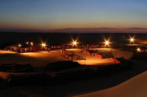 Experience the magic of the desert with private bivouac camping near Tozeur, Tunisia, as shown in this image of a secluded camp under star-filled skies. Surrounded by palm groves and sand dunes, this unique setting offers peace, privacy, and connection to the Sahara’s timeless beauty. Inspiration Africa organizes bespoke desert journeys that include fully serviced private camps, traditional cuisine, and unforgettable moments around the fire. Whether part of a romantic escape or an adventurous itinerary, your stay in Tozeur’s desert is crafted for comfort and authenticity. Let Inspiration Africa create your personalized desert experience in Tunisia.