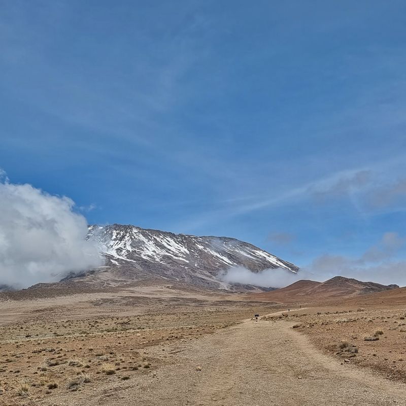 The snowcapped summit of Mount Kilimanjaro rises above the clouds, capturing the awe-inspiring final ascent toward Africa’s highest peak. Surrounded by glaciers, rugged volcanic terrain, and endless panoramic views, the mountain’s dramatic alpine landscape reflects both the challenge and beauty of one of the world’s most iconic trekking destinations. As climbers approach the summit, the crisp mountain air and vast horizon create an unforgettable sense of achievement and adventure in the heart of Tanzania. Inspiration Africa specializes in bespoke, tailor-made journeys across Tanzania and the African continent, crafting immersive travel experiences that combine adventure, natural beauty, and authentic discovery. From legendary safari destinations to the breathtaking heights of Kilimanjaro, every itinerary is carefully designed to create meaningful and unforgettable African journeys.