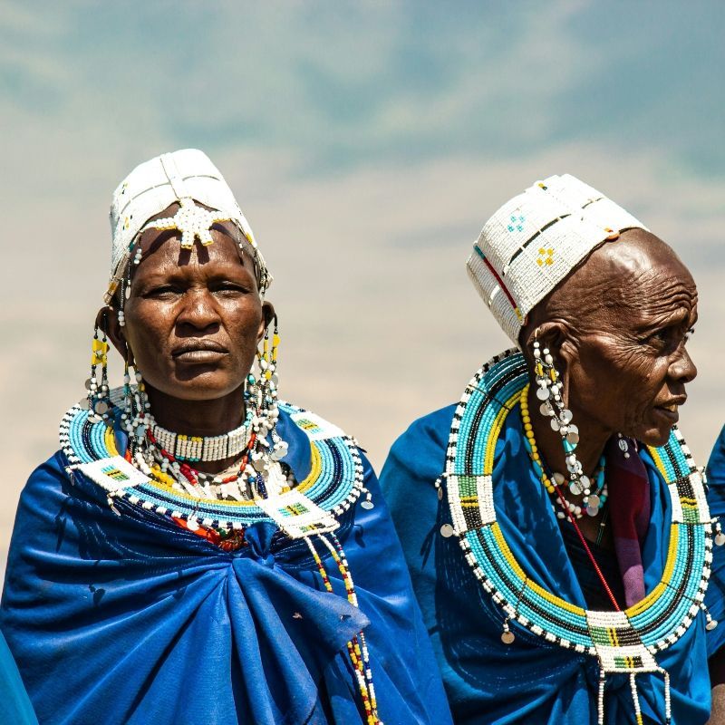 Two elderly Maasai women stand proudly in traditional blue attire within the Ngorongoro Conservation Area in Tanzania, embodying the rich cultural heritage and enduring traditions of the Maasai people. Their beautifully adorned garments, intricate beadwork, and dignified presence reflect generations of cultural knowledge and a deep connection to the land they have long inhabited. Set against the breathtaking landscapes of the Ngorongoro highlands, this portrait captures both the strength and grace of Maasai elder women, offering a powerful glimpse into one of East Africa’s most iconic indigenous communities.
Inspiration Africa specializes in bespoke, tailor-made journeys across Tanzania and the African continent, creating immersive travel experiences that connect travelers with authentic cultural encounters, extraordinary wildlife, and breathtaking landscapes. From visits to Maasai communities in the Ngorongoro Conservation Area to unforgettable safari adventures, every itinerary is carefully curated to reveal the beauty, diversity, and spirit of Africa.