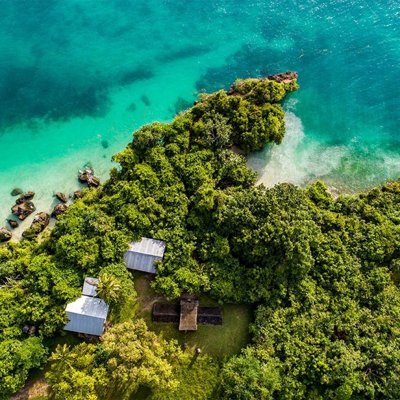 An aerial view showcases a pristine beach on Pemba Island, Tanzania, with powder-white sand, lush green vegetation, and turquoise waters of the Indian Ocean in this breathtaking travel photograph. Gentle waves lap along the shoreline, while the vibrant reef and varying shades of blue highlight the island’s rich coastal ecosystem. Pemba Island is renowned for its untouched beaches, vibrant marine life, and tranquil, secluded atmosphere, making it a paradise for travelers seeking natural beauty and serenity. Ideal for beach lovers, photographers, and nature enthusiasts, this scene captures the harmony of sand, sea, and tropical greenery in one of Tanzania’s most idyllic coastal destinations. Inspiration Africa specializes in bespoke, tailor-made journeys to Tanzania and across Africa, crafting unforgettable island escapes and extraordinary coastal experiences.