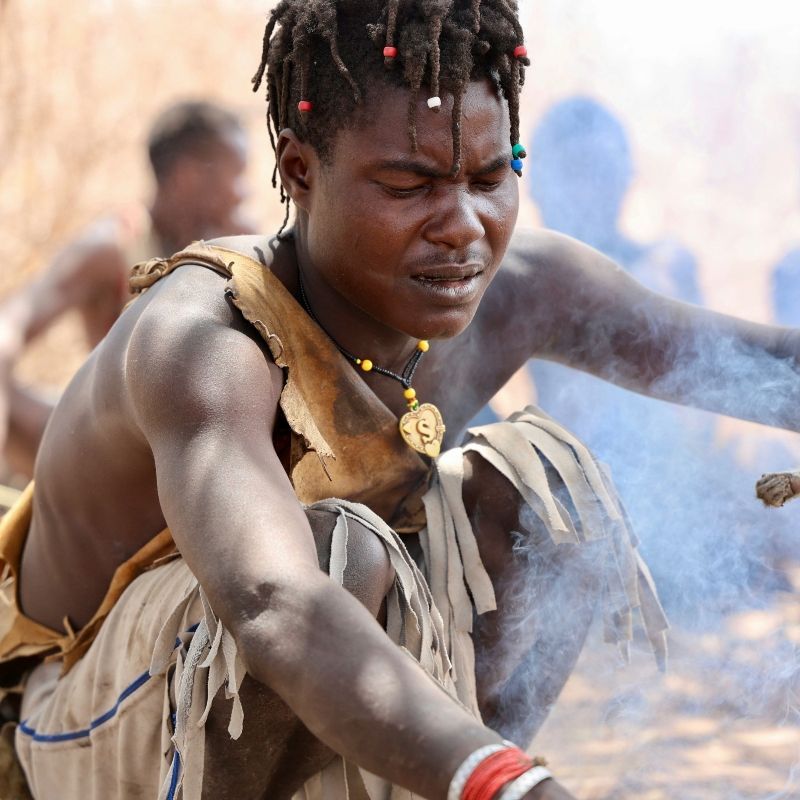 Witness the ancient skill of fire-making with this photo of a Hadzabe man in Tanzania. The image captures him focused on the crucial process of making a fire, demonstrating the traditional, self-sufficient lifestyle of this hunter-gatherer tribe. Inspiration Africa specializes in designing your unique, tailor-made trip to Tanzania for respectful cultural encounters and exploring other spectacular destinations across Africa. Experience the authentic traditions of the Hadzabe with us! Hadzabe Tribe