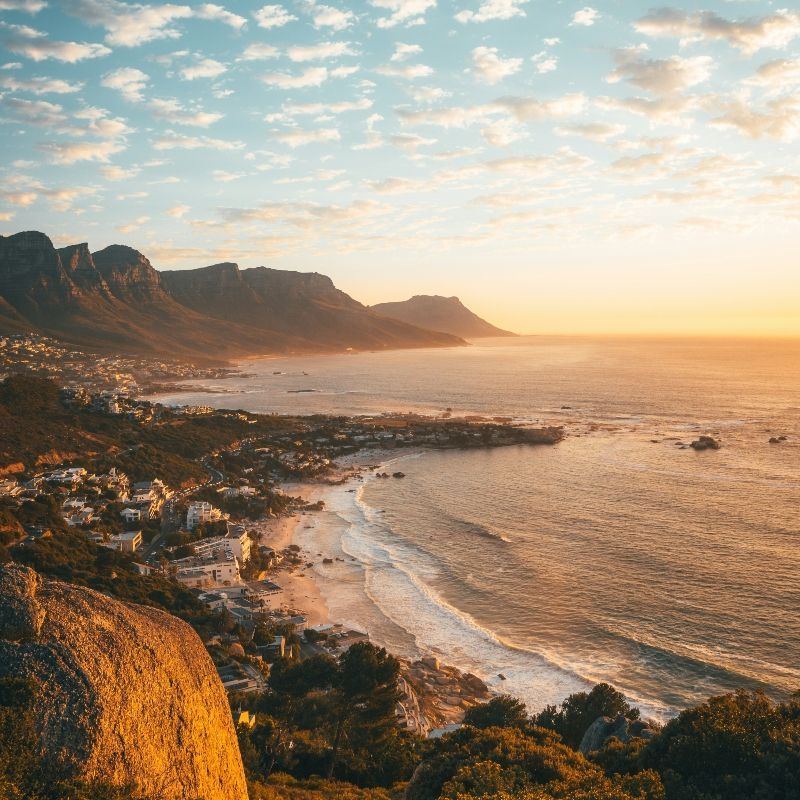 Admire the breathtaking beauty of Table Mountain at sunset, its iconic silhouette glowing beneath a sky painted in warm orange and pink hues over Cape Town, South Africa. This stunning scene captures the dramatic harmony between rugged peaks, coastal light, and the vibrant city below. Experiencing this view is a highlight of any South African journey. Let Inspiration Africa craft your bespoke, tailor-made trip to explore Cape Town’s most unforgettable landscapes. Start planning your extraordinary adventure with us today!