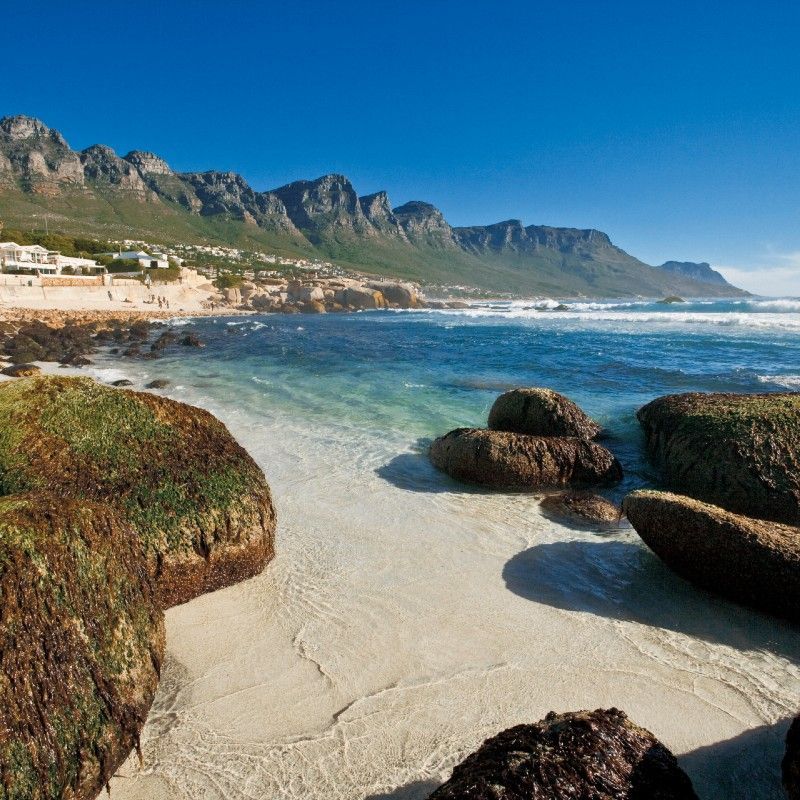 The dramatic Twelve Apostles mountain range rises majestically along the Atlantic coastline of Cape Town, South Africa, captured in this breathtaking travel photograph. Framed by rugged cliffs and the deep blue ocean, the iconic peaks form part of Table Mountain National Park and offer some of the most scenic coastal views in the world. Known for spectacular sunsets, hiking trails, and panoramic vistas, the Twelve Apostles highlight Cape Town’s unique blend of mountains and sea. Ideal for nature lovers, photographers, and adventure travelers, this scene showcases the natural beauty and grandeur of South Africa’s most iconic landscapes. Inspiration Africa specializes in bespoke, tailor-made journeys to South Africa and across Africa, crafting authentic travel experiences that feature extraordinary scenery and unforgettable destinations.