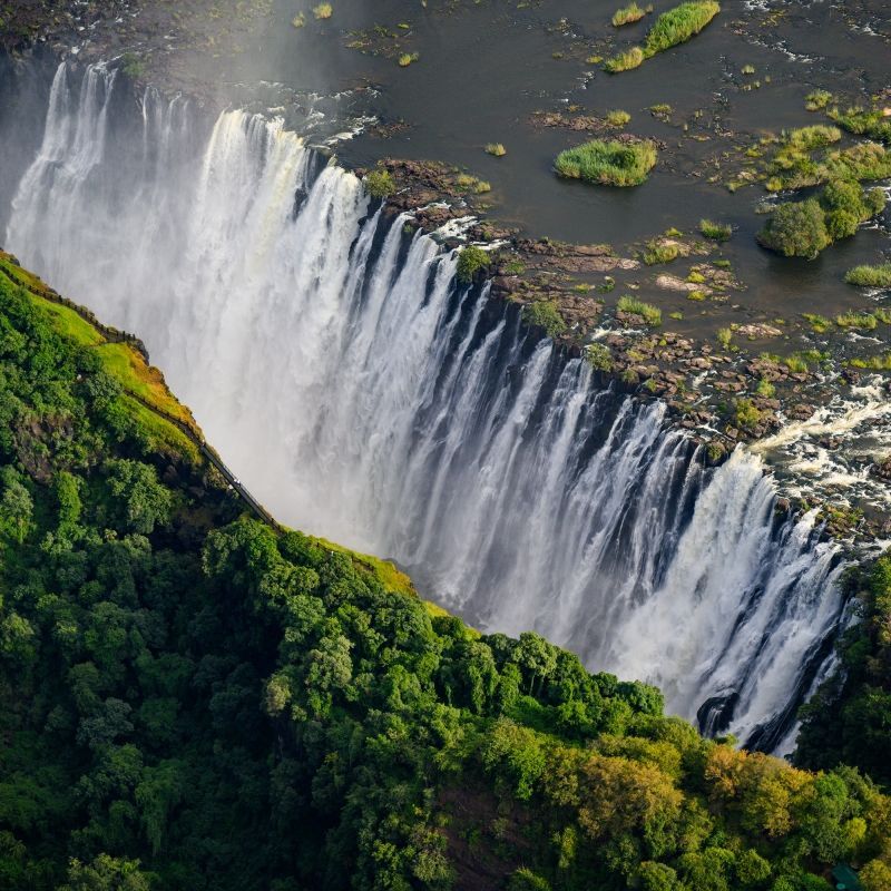 Gaze upon a spectacular balloon flight soaring above Victoria Falls in Zimbabwe, captured in this breathtaking aerial photograph. The balloon floats gently over the Zambezi River as mist rises from the thundering falls below, revealing the immense scale and power of one of the world’s greatest natural wonders. From above, the surrounding rainforest, gorge, and river create a dramatic and unforgettable landscape. Experiencing Victoria Falls by balloon offers a rare and serene perspective on this UNESCO World Heritage Site. Inspiration Africa specializes in designing bespoke, tailor-made journeys that combine iconic landmarks with extraordinary, once-in-a-lifetime experiences across Africa.