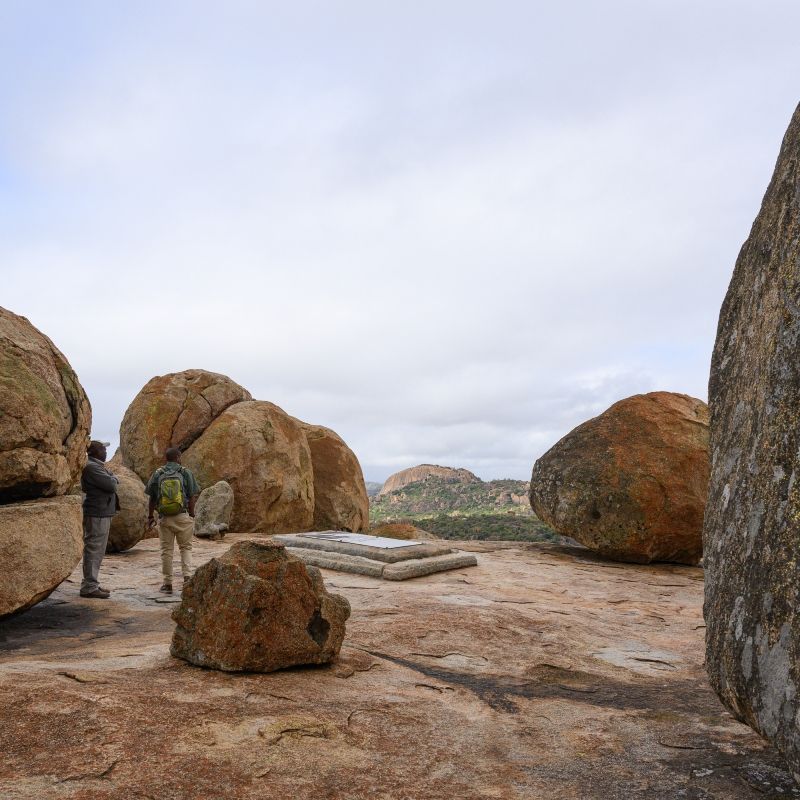 Matobo (Matopos) National Park in Zimbabwe is captured in this evocative travel photograph, showcasing its dramatic landscape of massive granite kopjes, balancing boulders, and sweeping open vistas. Ancient rock formations rise from the earth in sculptural shapes, softened by grasslands and scattered trees that give the park its distinctive character. The play of light and shadow across the rocks highlights the park’s spiritual and geological significance, while the sense of space and silence conveys a deep connection to nature. This scene reflects the timeless beauty, cultural importance, and quiet wilderness of Matobo National Park, a UNESCO World Heritage Site rich in history, wildlife, and rock art. Inspiration Africa specializes in bespoke, tailor-made journeys to Zimbabwe and across Africa, crafting unforgettable travel experiences in extraordinary destinations.