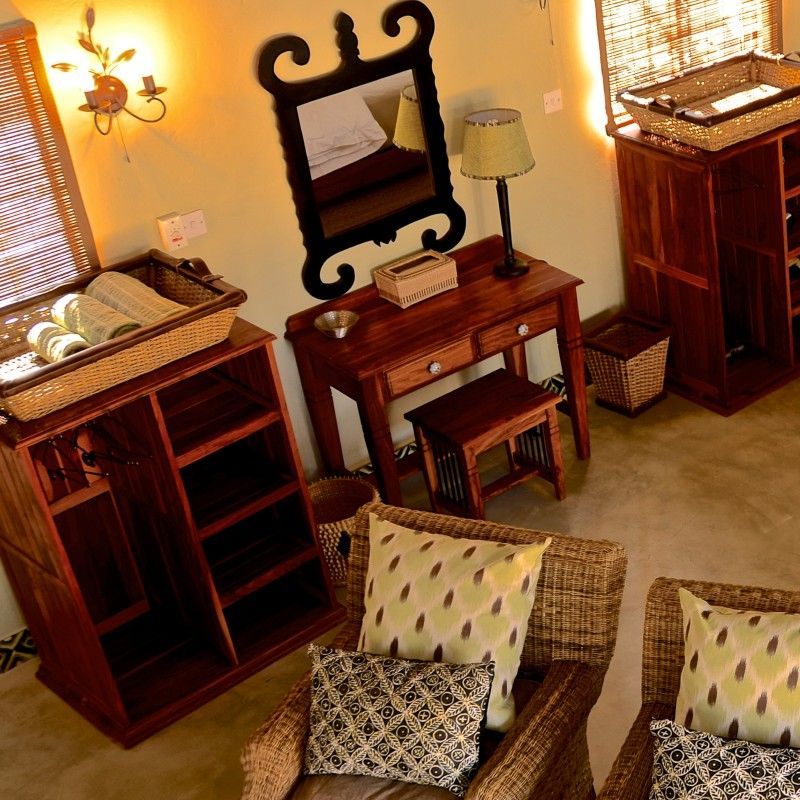 The interior of one of the rooms at Camelthorn Imvelo Lodge in Zimbabwe is captured in this inviting travel photograph, showcasing a comfortable and elegantly designed space set within the bush. A well-appointed bed, natural wooden furnishings, and soft neutral tones create a warm and relaxing atmosphere that reflects the textures and colors of the surrounding wilderness. Large windows allow natural light to fill the room and offer unobstructed views of the lodge grounds and nearby wildlife, enhancing the sense of immersion in nature. The interior balances understated luxury with authentic safari-style living, providing guests with a tranquil retreat in one of Zimbabwe’s most scenic and wildlife-rich regions. Inspiration Africa specializes in bespoke, tailor-made journeys to Zimbabwe and across Africa, crafting unforgettable safari experiences in extraordinary wilderness destinations.