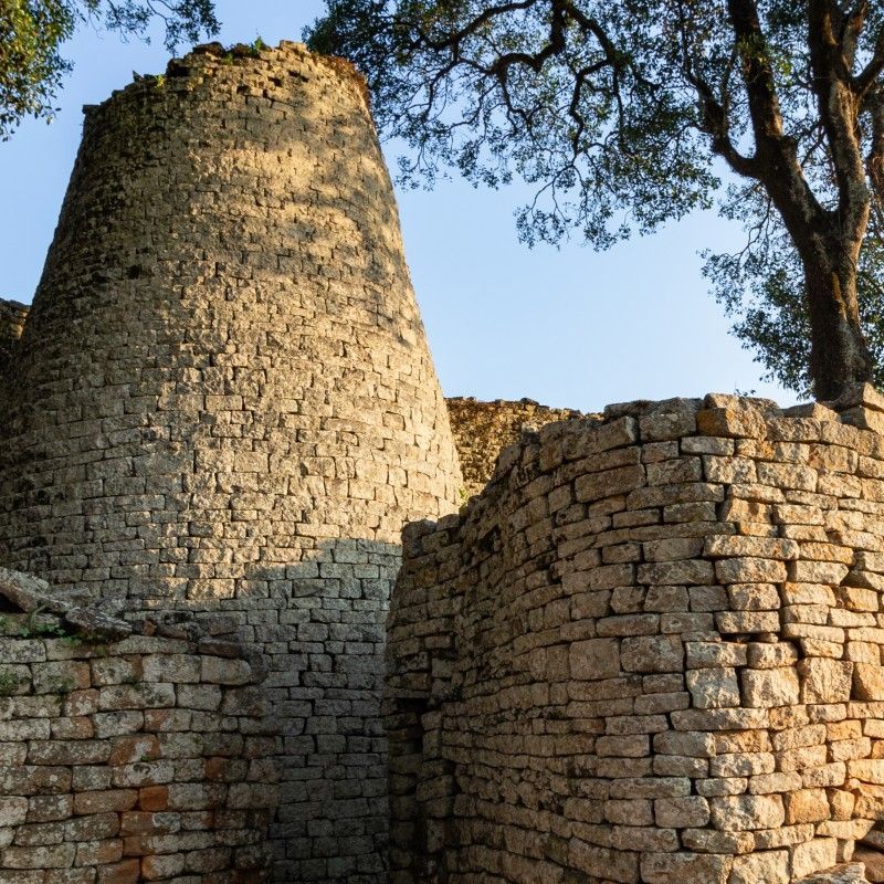 The ancient Great Zimbabwe Ruins in Zimbabwe are captured in this striking travel photograph, showcasing one of Africa’s most significant archaeological sites. The stone walls, circular towers, and intricate ruins reflect the power and sophistication of the Kingdom of Zimbabwe, which thrived between the 11th and 15th centuries. Set against rolling hills and open savannah, the site offers a glimpse into the region’s rich history, trade networks, and architectural mastery. Ideal for history enthusiasts, culture lovers, and photographers, Great Zimbabwe provides a profound connection to Africa’s pre-colonial heritage and civilization. Inspiration Africa specializes in bespoke, tailor-made journeys to Zimbabwe and across Africa, crafting authentic travel experiences that explore extraordinary historical landmarks and cultural heritage.