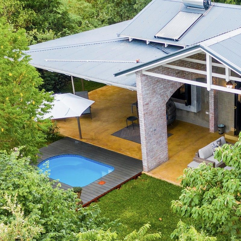 The swimming pool and exterior of Mbano Manor in Zimbabwe are captured in this inviting travel photograph, showcasing a serene and elegant retreat surrounded by lush gardens and mature trees. The pool’s calm waters reflect the bright skies and the manor’s stylish architecture, while sun loungers and shaded areas provide welcoming spaces for relaxation. The building’s design blends classic comfort with its natural surroundings, creating a tranquil and harmonious atmosphere for guests. The scene conveys the essence of a peaceful stay at Mbano Manor, combining scenic beauty, luxury, and a connection to Zimbabwe’s landscape. Inspiration Africa specializes in bespoke, tailor-made journeys to Zimbabwe and across Africa, crafting unforgettable travel experiences in extraordinary destinations.