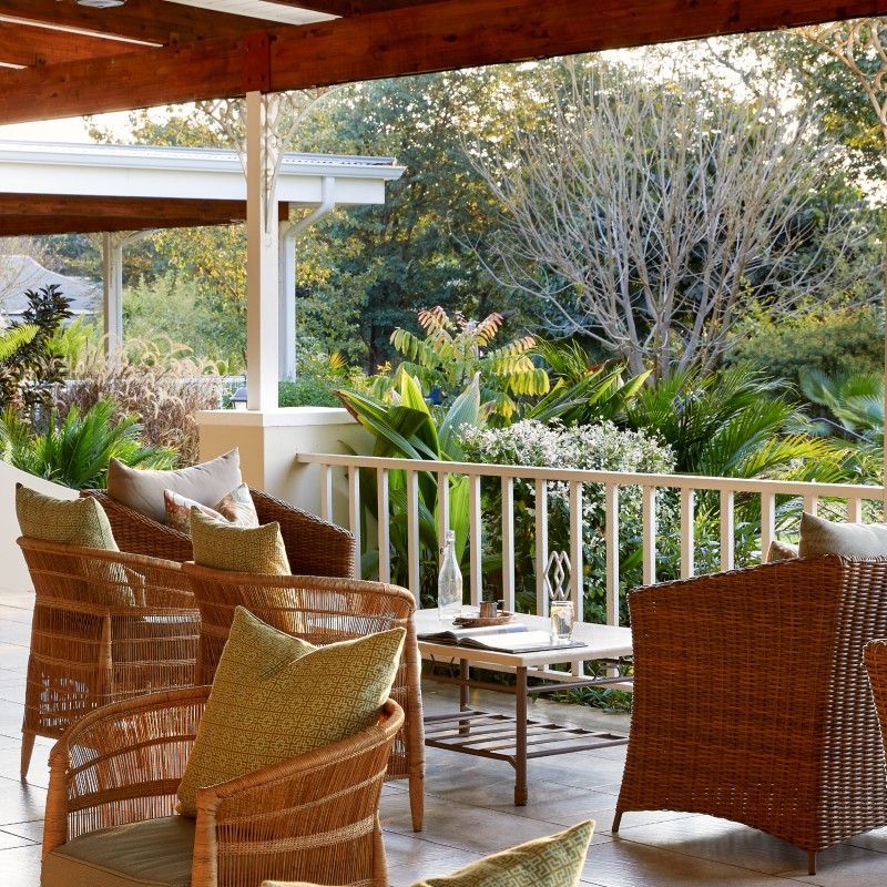 The outdoor dining area at Pioneers Lodge in Zimbabwe is featured in this inviting travel photograph, set within peaceful gardens and shaded by mature trees. Tables are arranged in an open-air setting, allowing guests to enjoy meals surrounded by greenery and fresh air. Natural materials and simple, elegant design create a relaxed and welcoming atmosphere, while soft light enhances the sense of comfort and tranquility. The scene reflects the lodge’s charm as a restful retreat near Victoria Falls, offering a balance of comfort, hospitality, and connection to the outdoors. Inspiration Africa specializes in bespoke, tailor-made journeys to Zimbabwe and across Africa, crafting unforgettable travel experiences in extraordinary destinations.