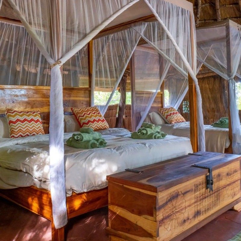 The interior of a tented bedroom at McBride’s Camp in Zambia is captured in this inviting travel photograph, highlighting a refined combination of comfort, style, and immersion in the surrounding wilderness. Warm tones, natural materials, and carefully chosen furnishings create a serene and welcoming atmosphere, while soft natural light filters through the tent’s windows, connecting the interior with the bush and riverine landscapes outside. Thoughtful design details, from textiles to décor accents, emphasize relaxation, elegance, and harmony with nature. Inspiration Africa curates bespoke, tailor-made journeys to Zambia and across Africa, combining luxury safari accommodations with unforgettable wildlife encounters and immersive safari experiences.
