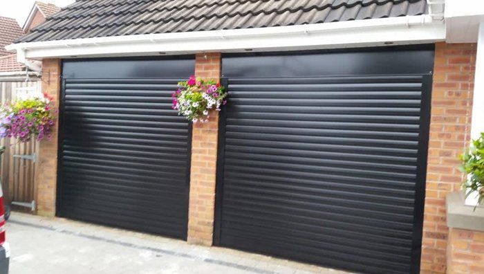 Twin black roller shutter doors