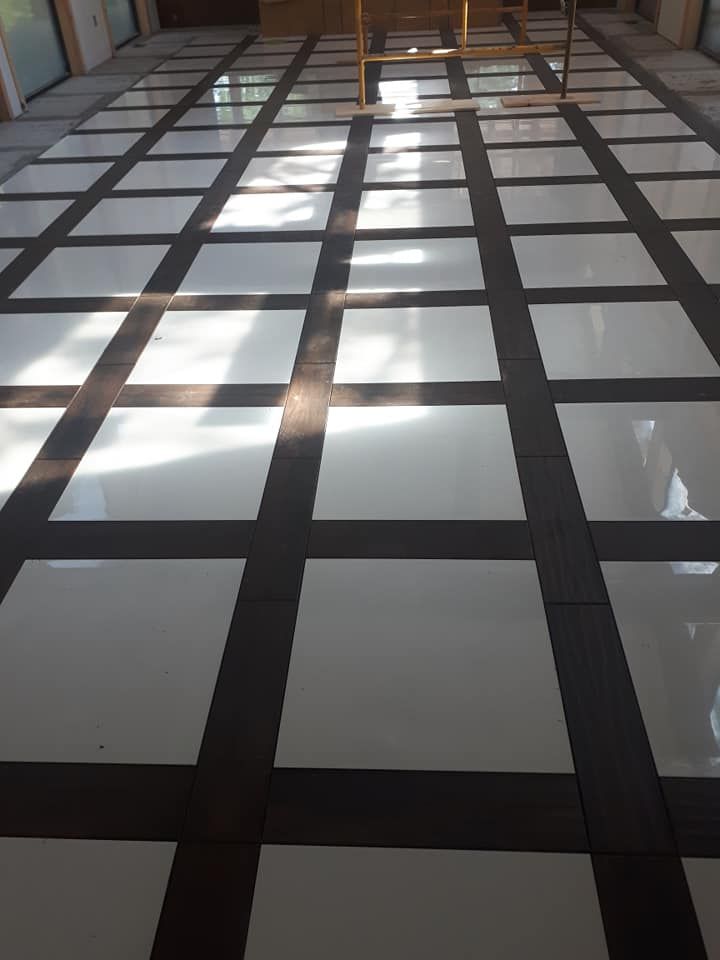 A black and white tiled floor with a grid pattern.