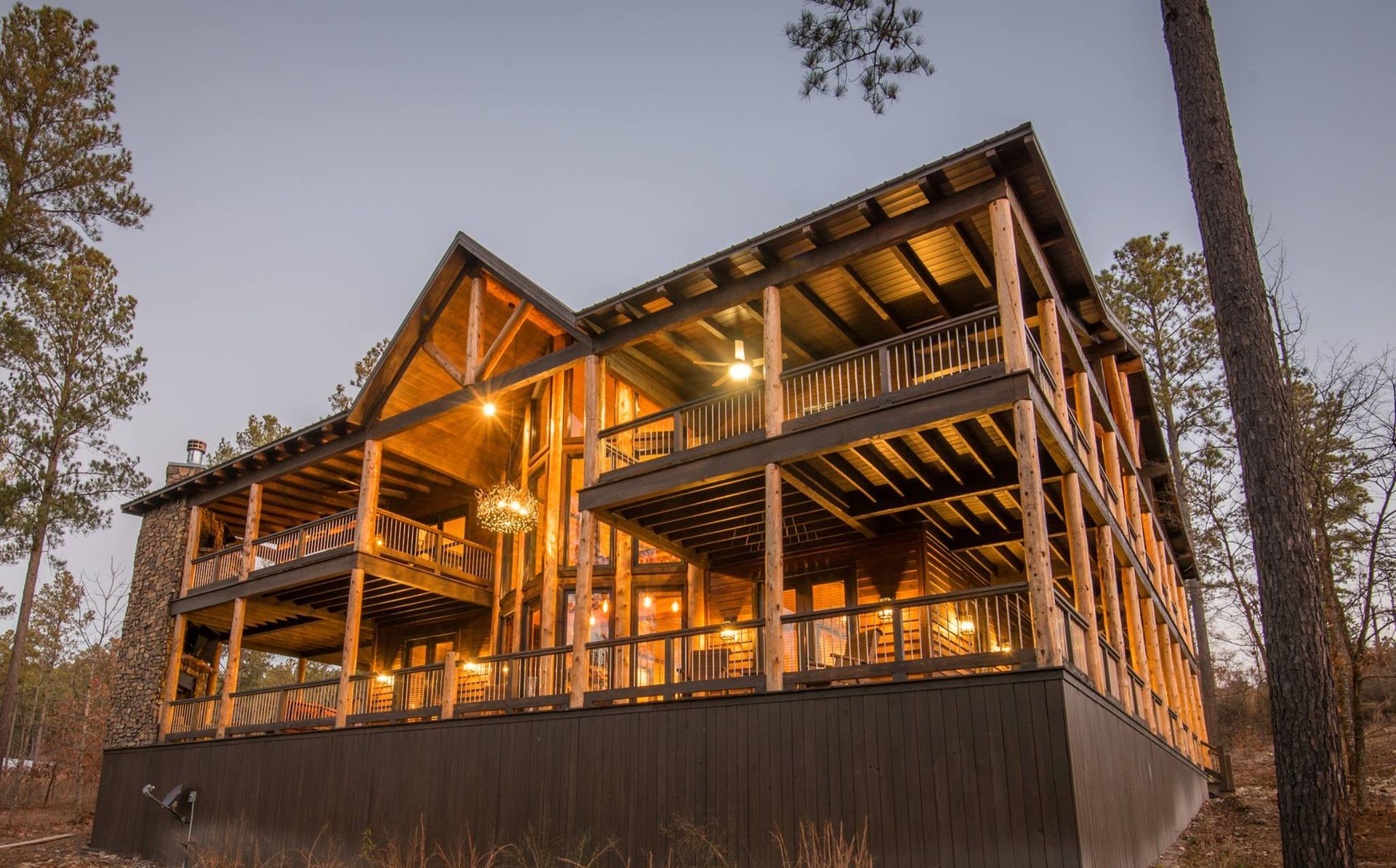 A large log cabin is being built in the middle of a forest.