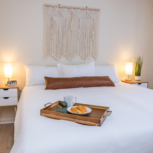 A bed with a tray of food on it