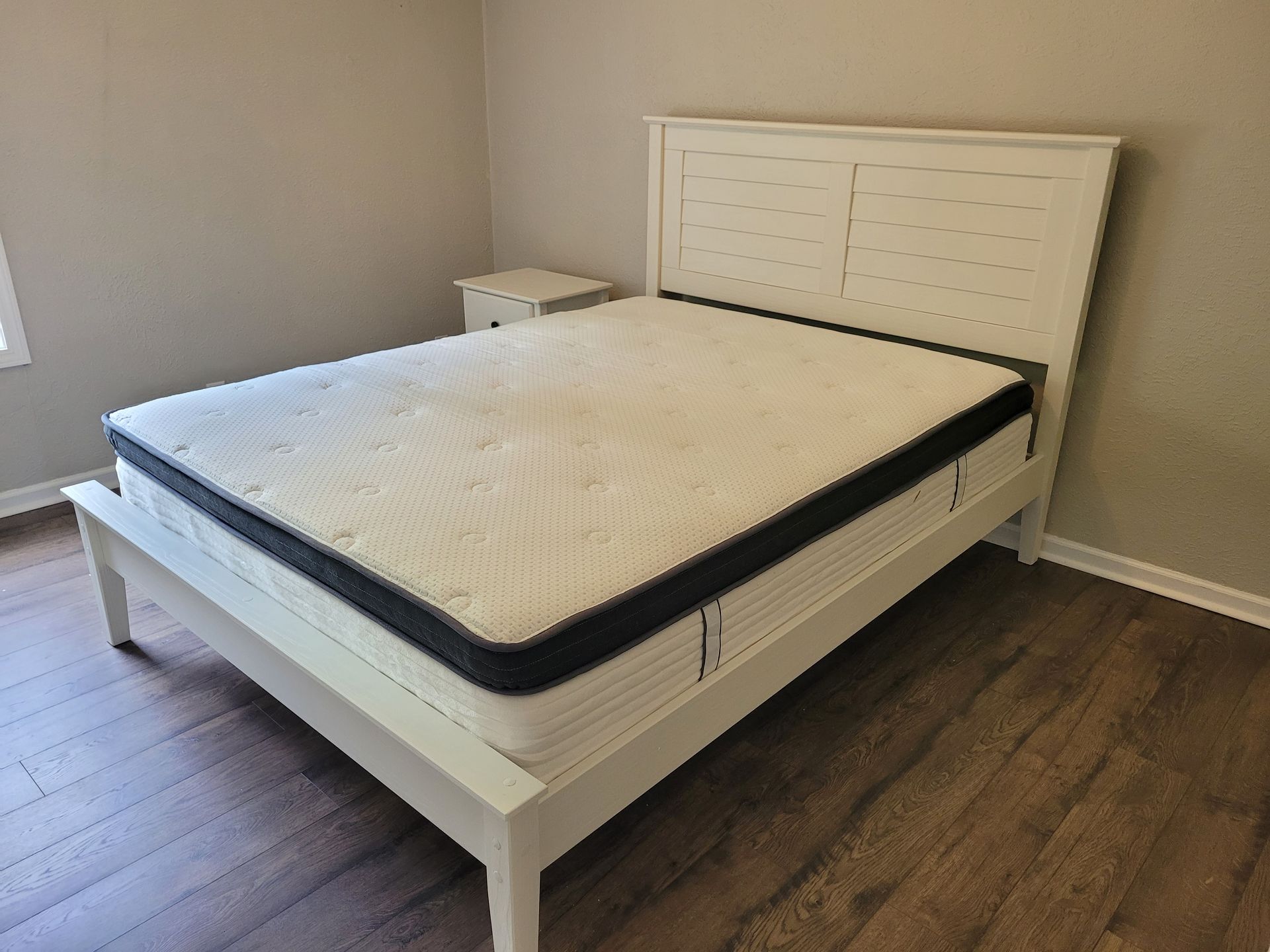 A bed with a mattress on top of it in a bedroom.