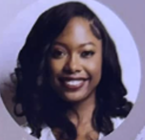 Smiling Black woman with dark hair and burgundy lipstick.