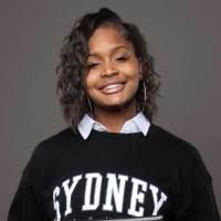Young Black woman smiling, wearing a black 