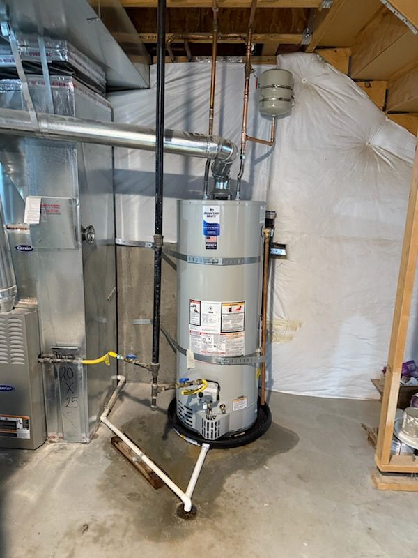 Basement utility room with a large water heater, metal ductwork, and storage shelves