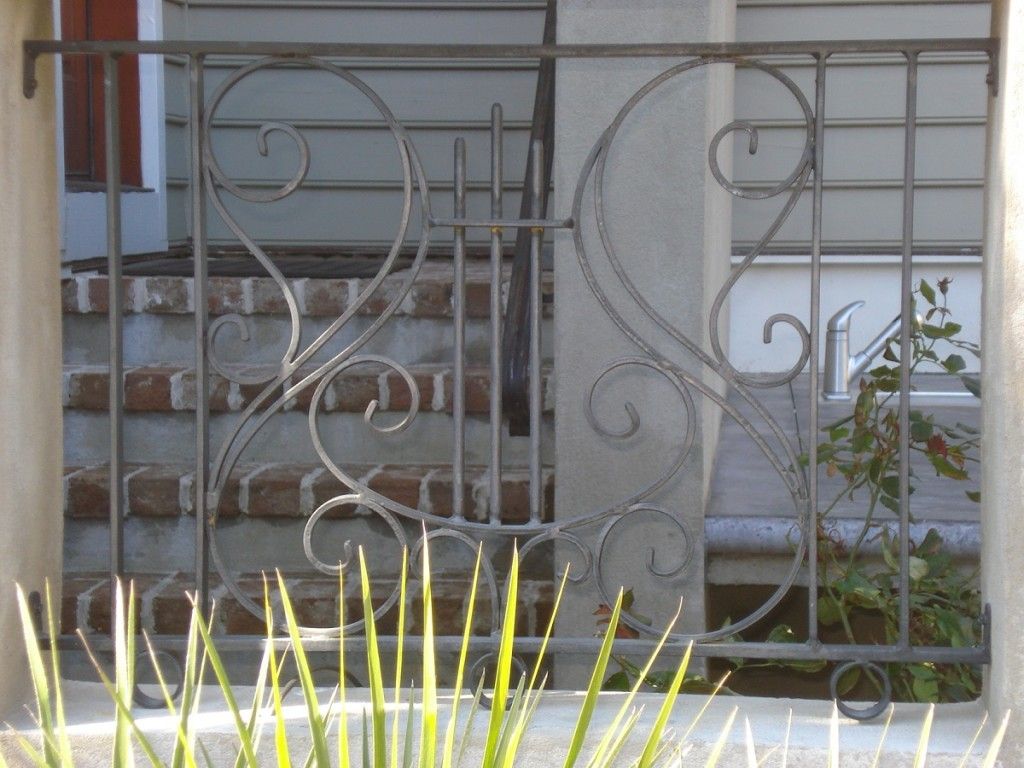A wrought iron fence surrounds a set of stairs