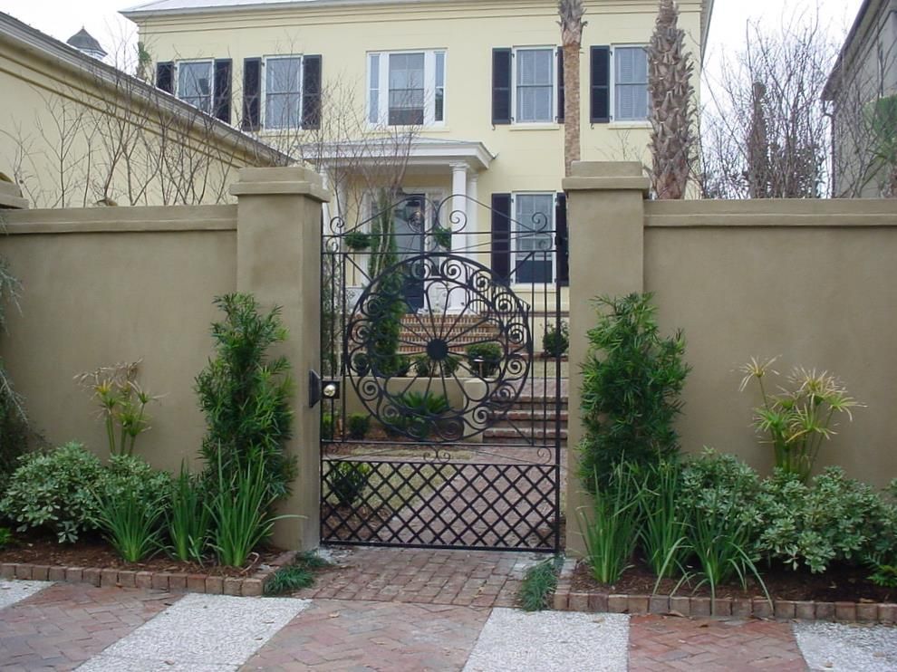 A house with a fence and a gate in front of it