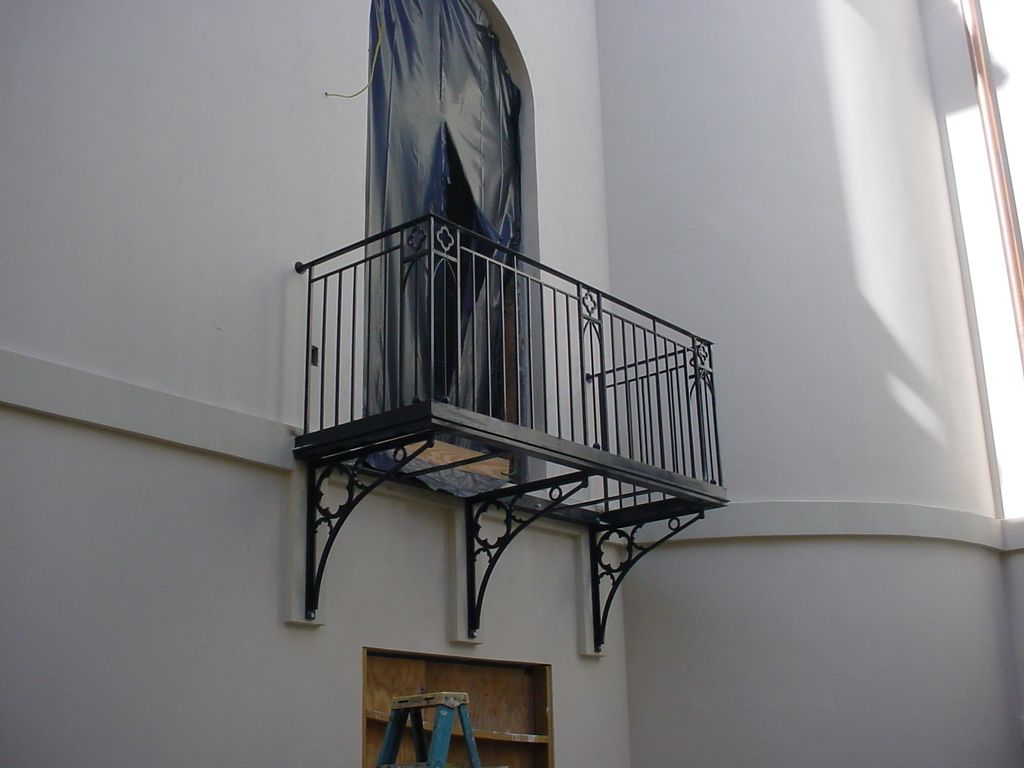 A balcony is attached to the side of a building