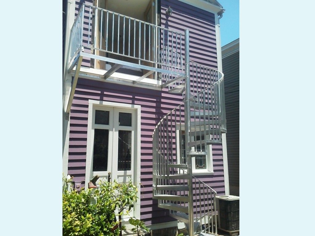 A purple house with a spiral staircase leading up to the second floor