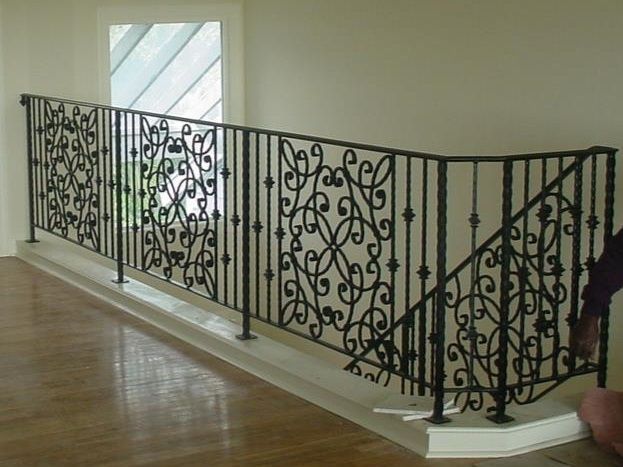 A wrought iron railing on a staircase in a house