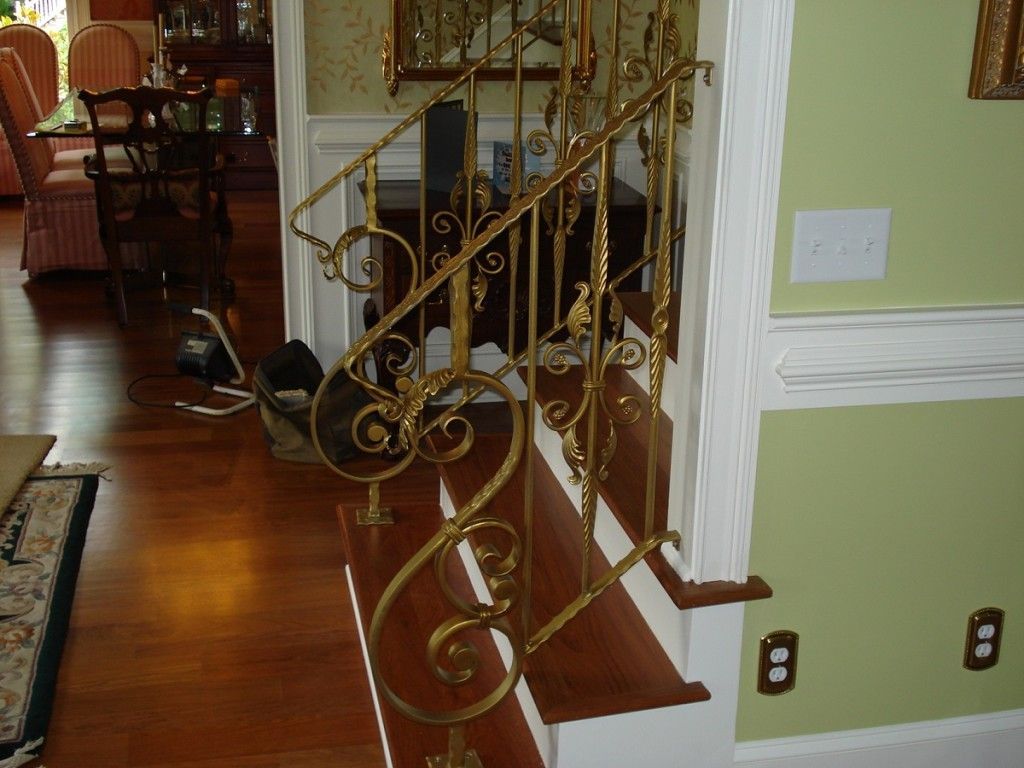 A wrought iron railing on a set of stairs in a house