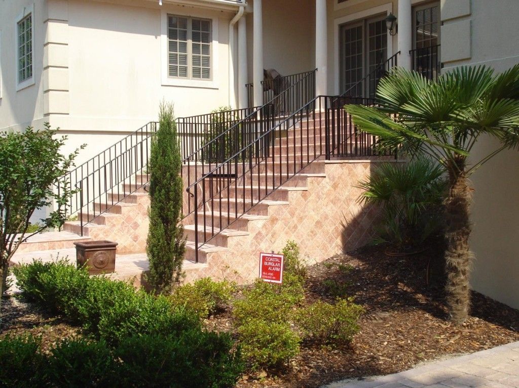 A house with stairs and a sign that says
