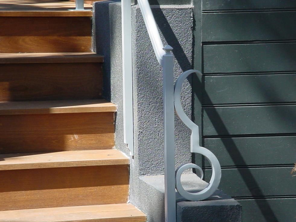 A set of wooden stairs with a white railing