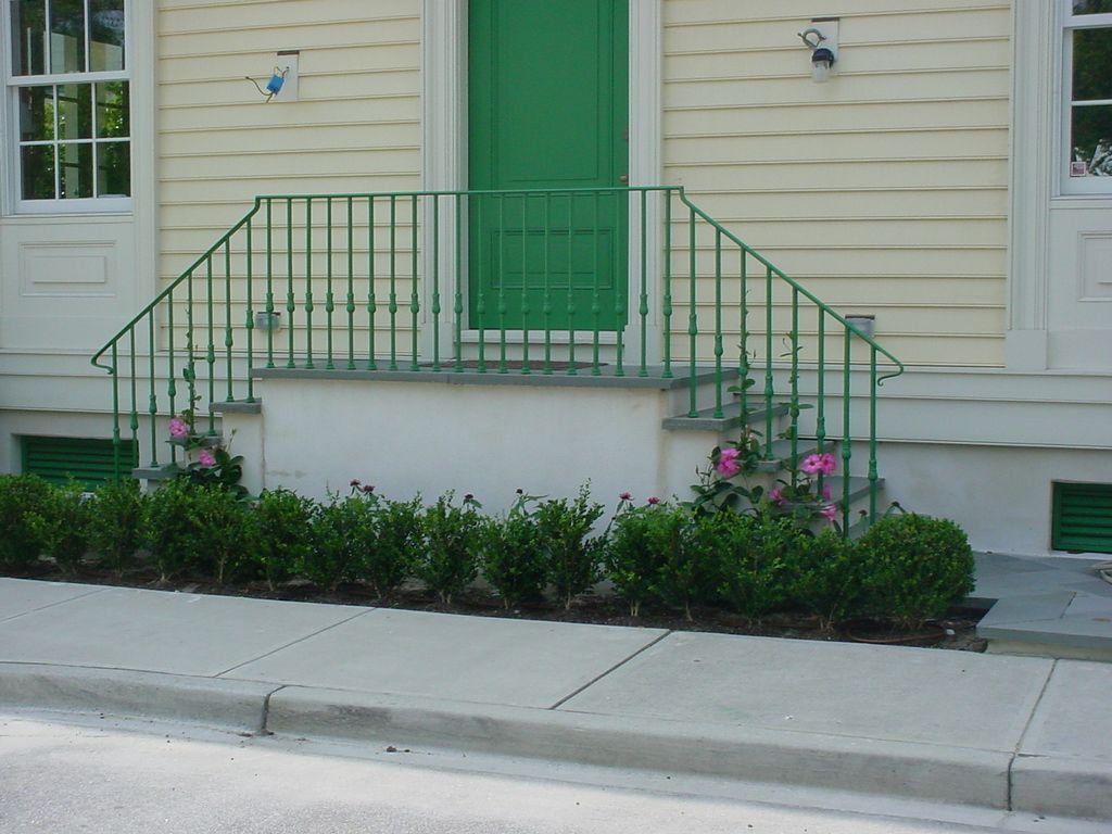 A house with a green door and a green railing