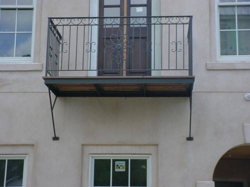 A balcony on the side of a building with a door