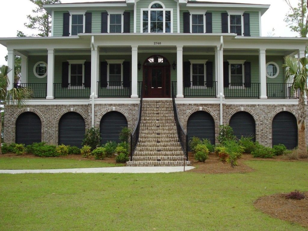 A large house with stairs leading up to the front door