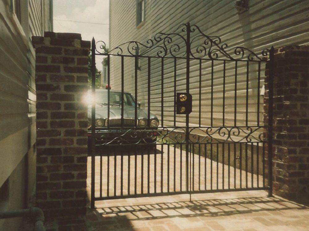 A wrought iron gate with a mailbox on it