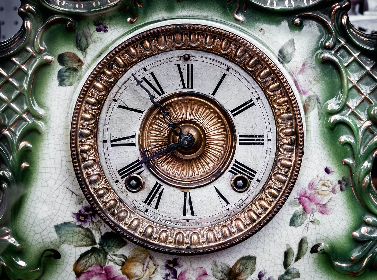 A close up of a clock with roman numerals on it.