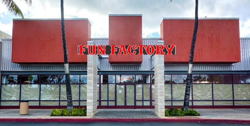A building with a red roof and a sign that says fun factory