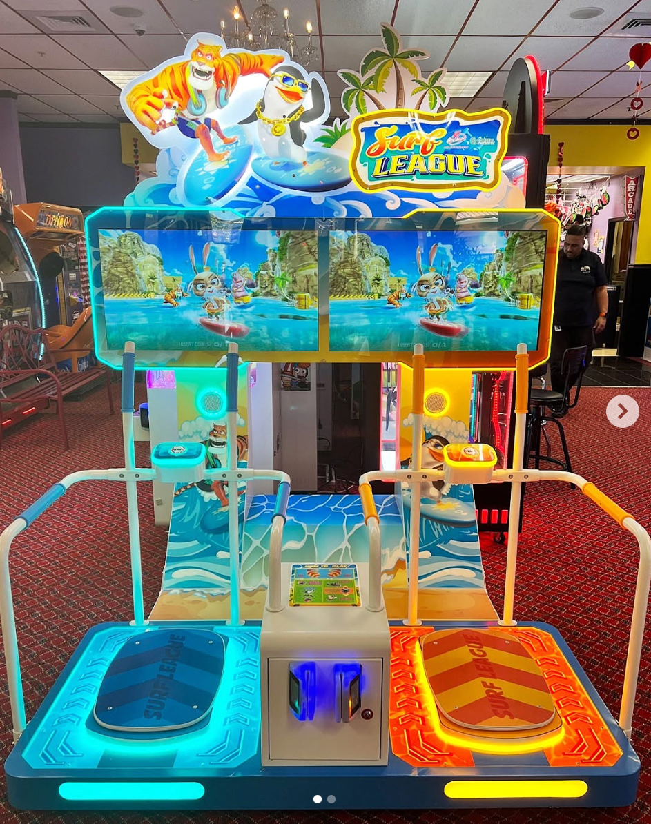 An arcade game with a dolphin on top of it.