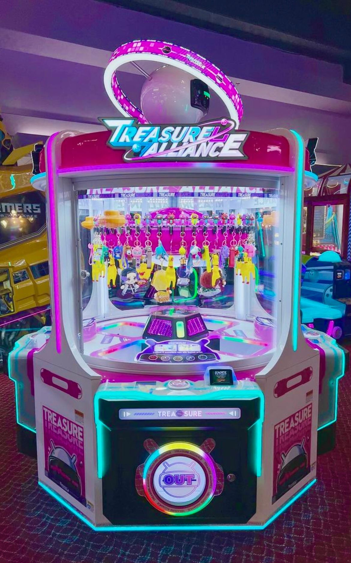 A treasure alliance arcade game is sitting in an amusement park.