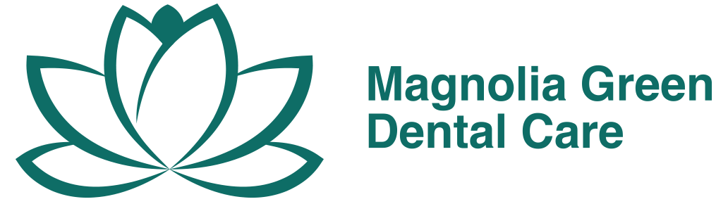 The logo for magnolia green dental care has a lotus flower on it.