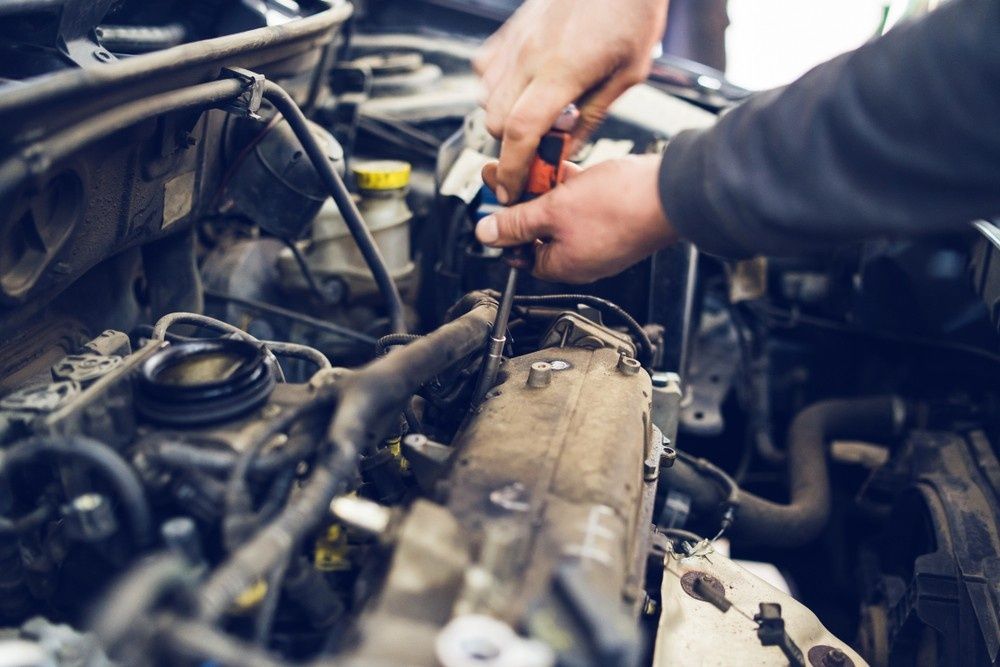 Mechanic Working on Car Engine with A Screwdriver — Ryder's Garage in Copacabana, NSW