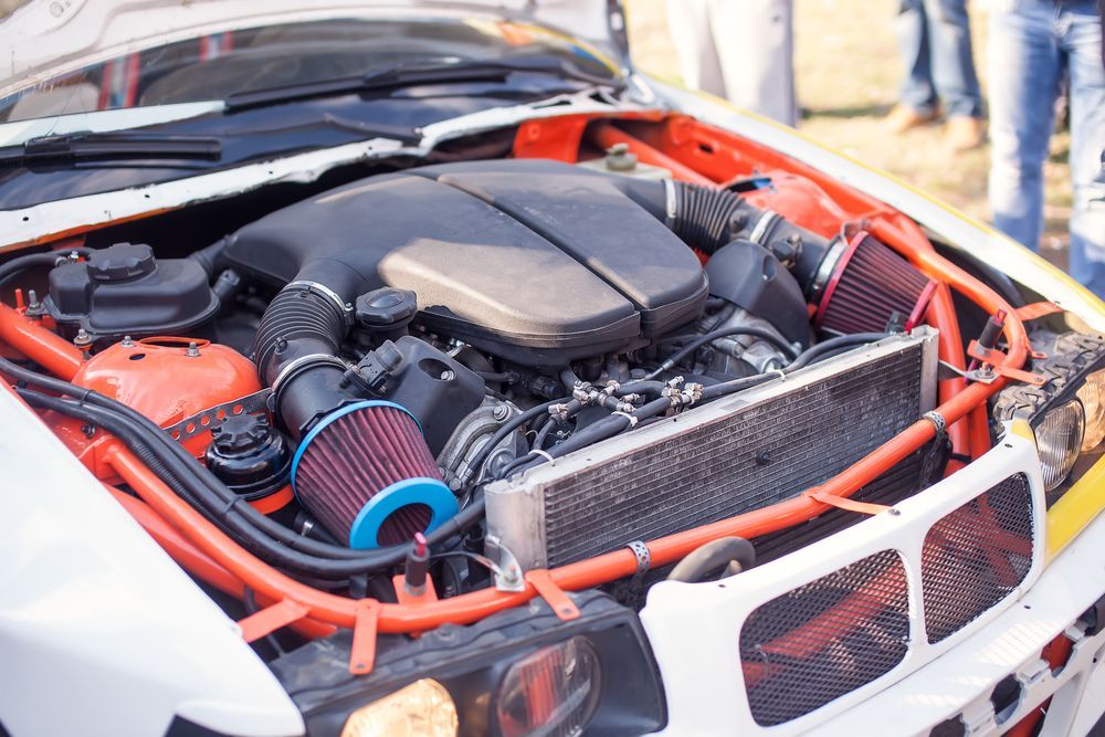 Modified Car Engine Bay with Bright Red Piping and A Blue Air Filter — Ryder's Garage in MacMasters Beach, NSW