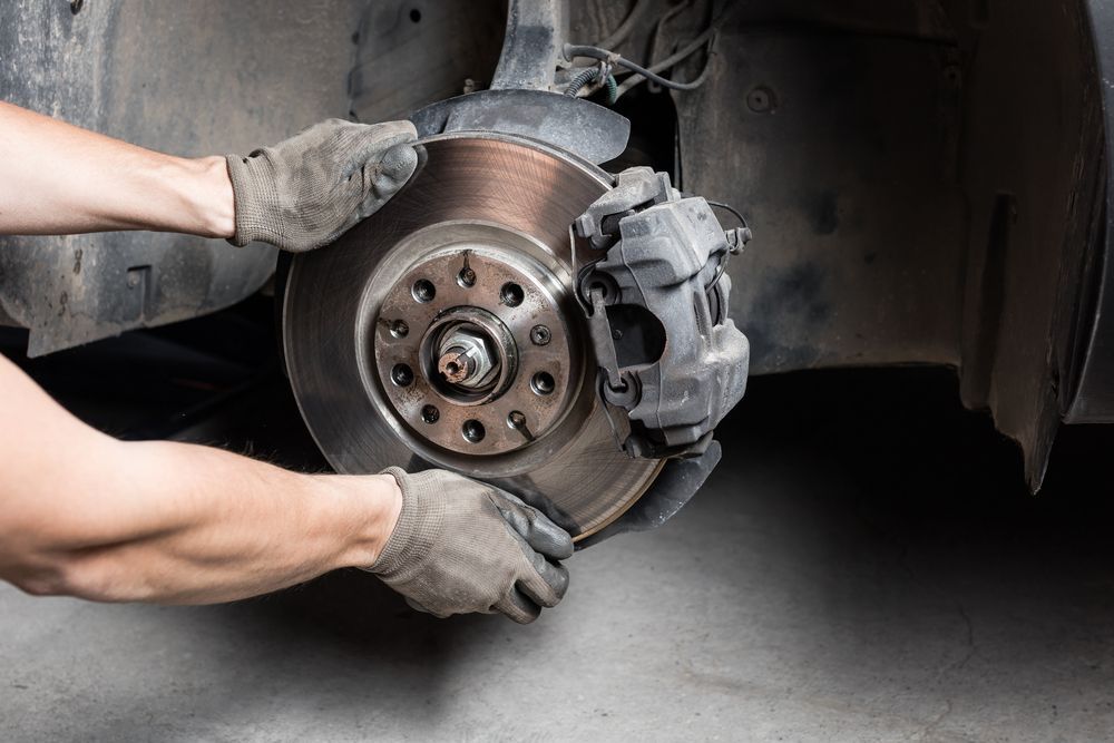 Mechanic Replacing a Car Brake Rotor and Caliper with Gloved Hands — Ryder's Garage in MacMasters Beach, NSW