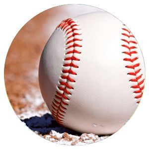 Close-up of a white baseball with red stitching resting on dirt and chalk lines