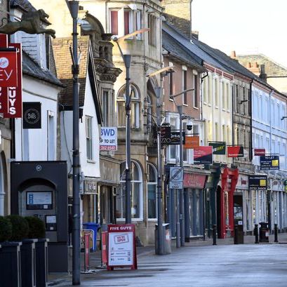 A row of buildings with a sign that says five guys